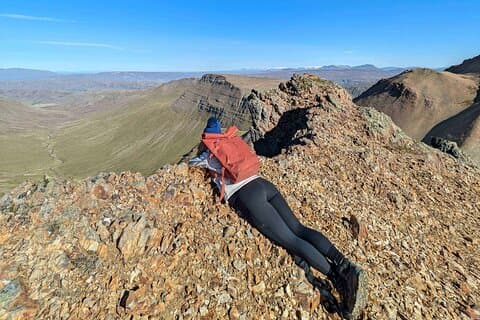 Hiker lying on the edge