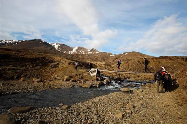 Hikers crossing a bridge