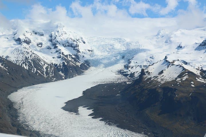 Airplane flight over glacier lagoons and Iceland's highest peak