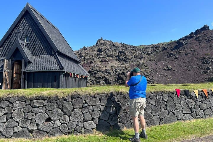 Traveler taking pictures of the Viking black church