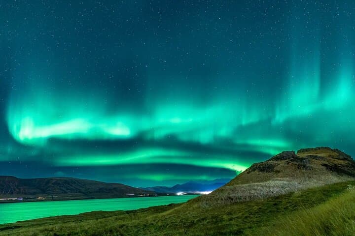 Spectacular aurora display over a fjord