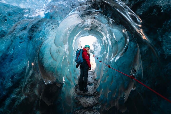 Admire the intricate textures and ancient air bubbles trapped within the walls of the ice cave