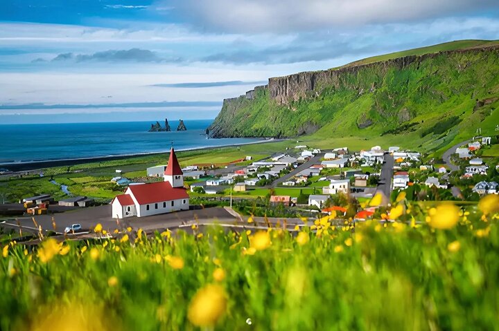 Explore the charming village of Vík framed by Iceland’s raw scenery